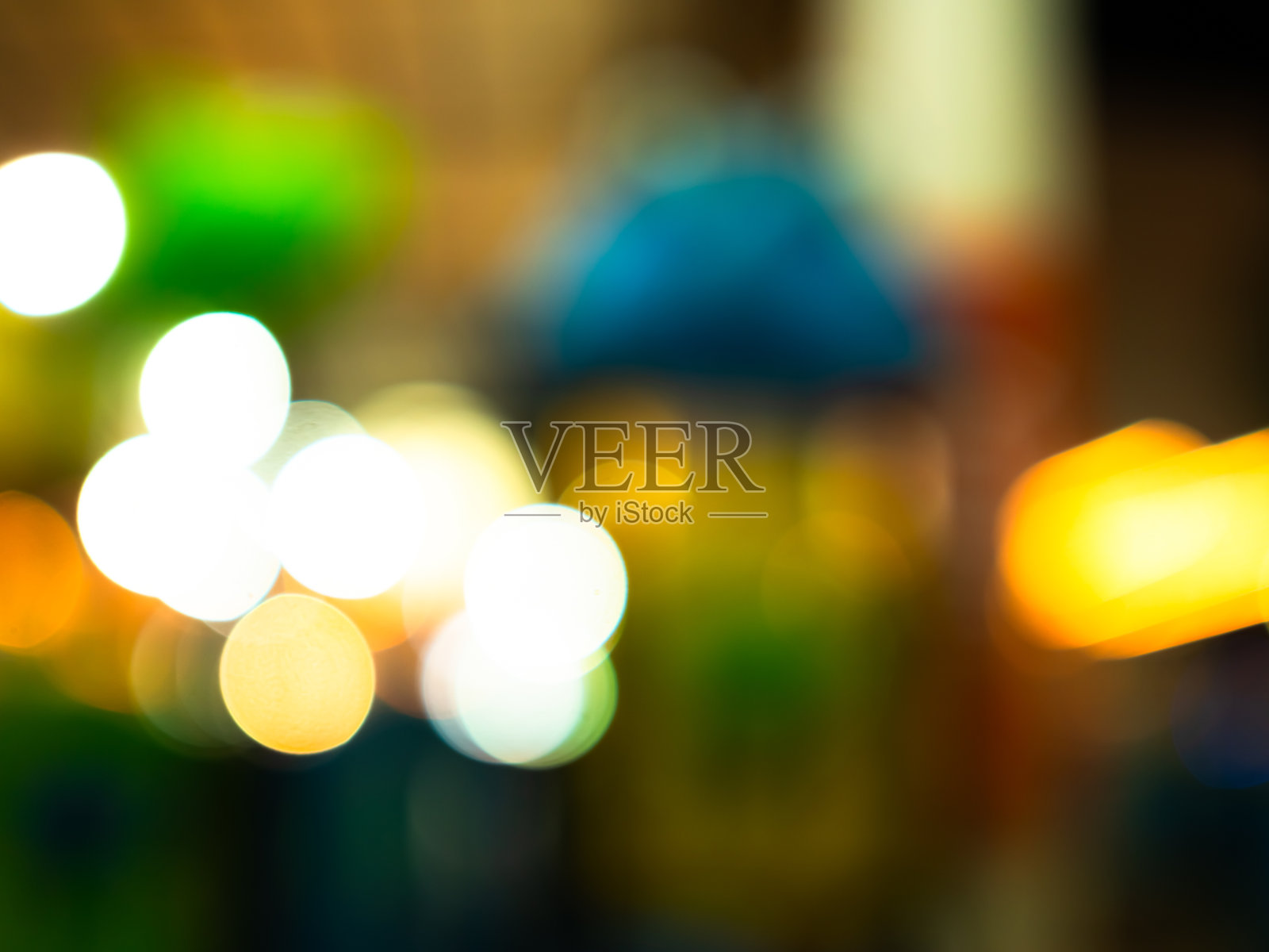 模糊的背景光点闪烁抽象圆圈光晕效果图案，城市中节日的圣诞快乐和新年夜，奢华的卡片派对旅行，明亮的魔幻圣诞灯光。照片摄影图片