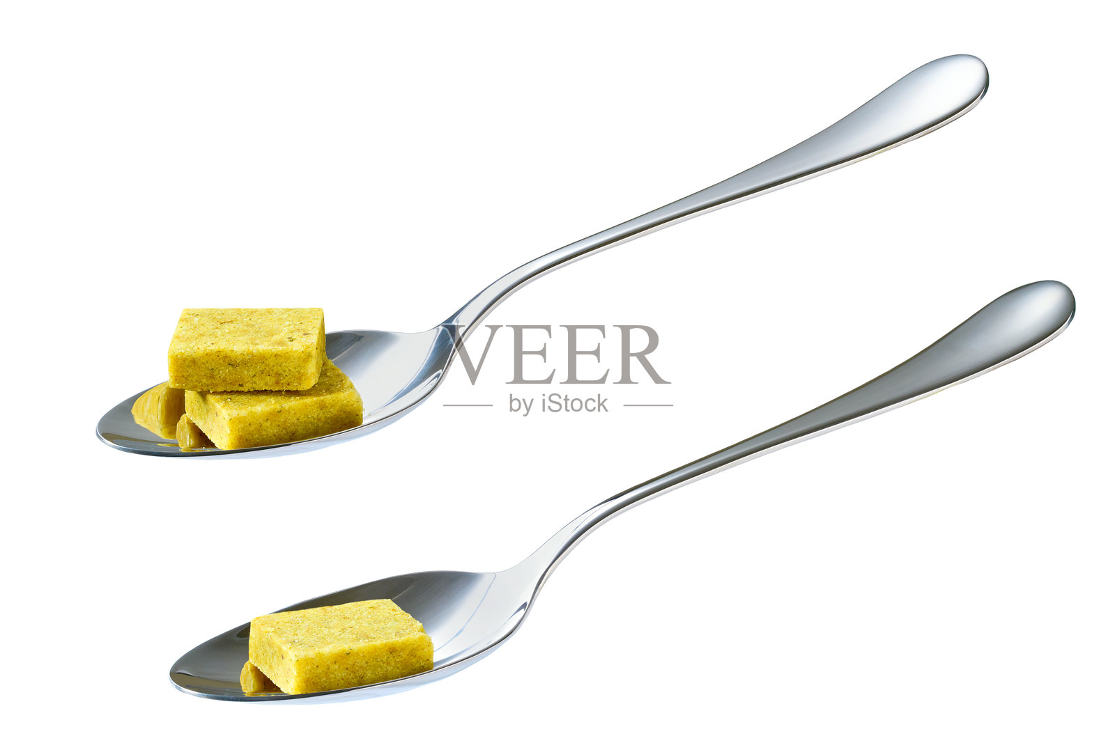 金属勺子中的高汤块，背景为白色。照片摄影图片