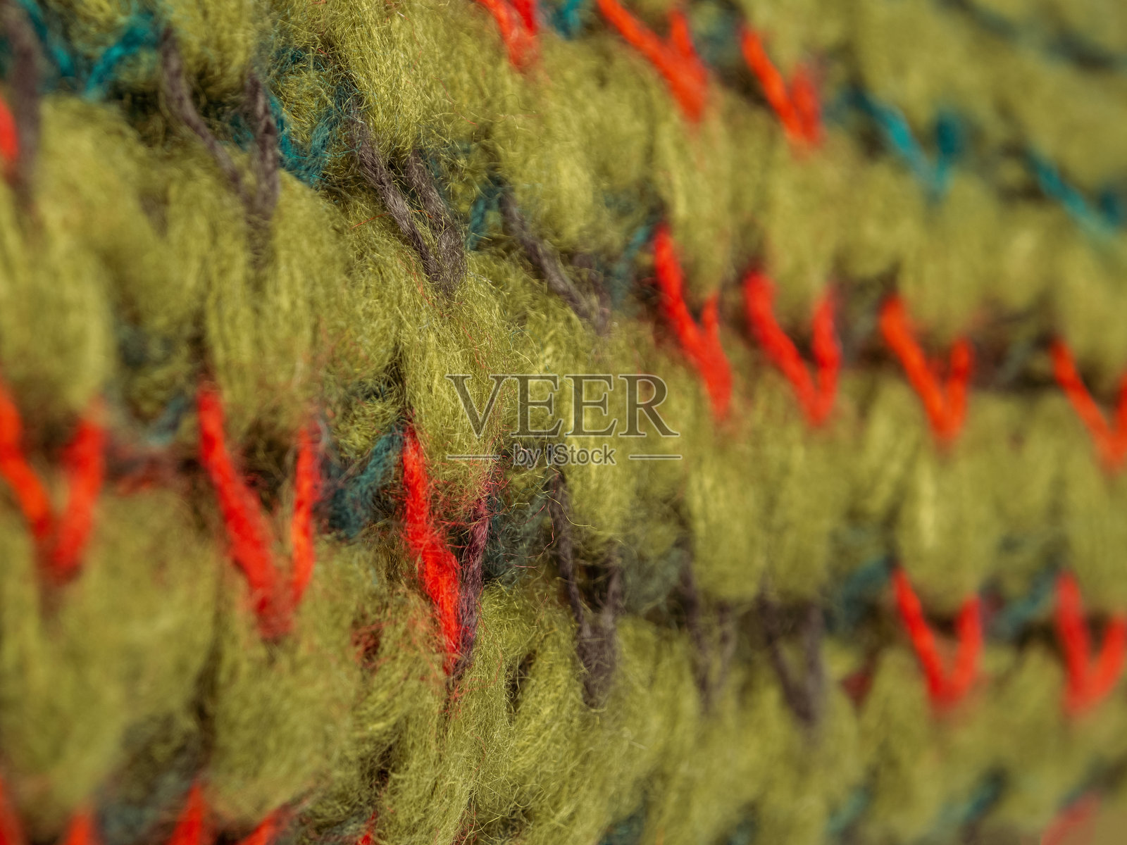 明亮绿色的针织羊毛围巾特写。细致的纹理和丰富的色彩突显了这款时尚围巾的品质和舒适感。照片摄影图片