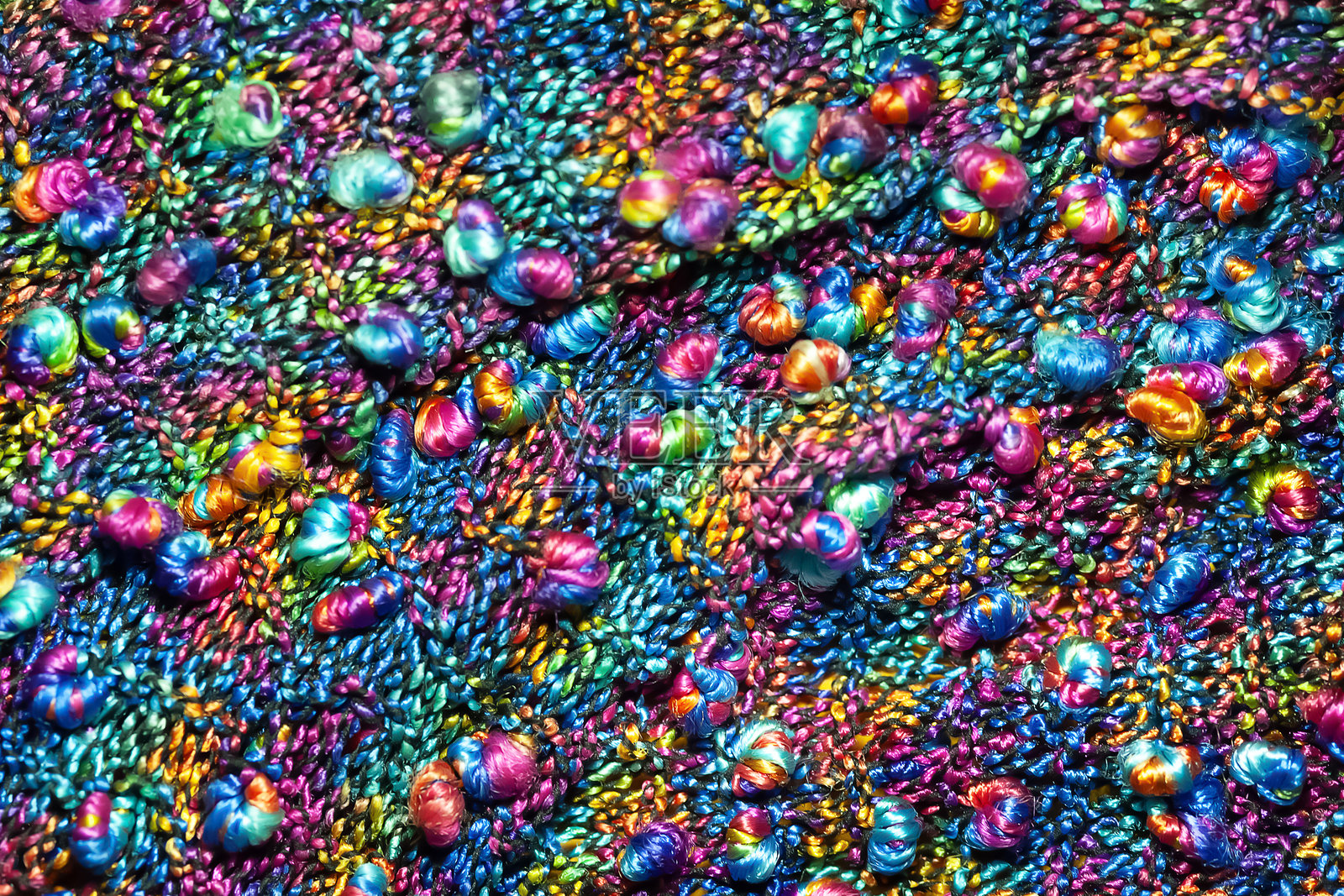 针织表面。针织面料纹理。温暖的针织产品。多彩的线材。照片摄影图片