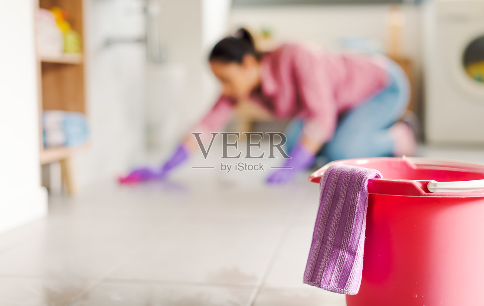 女人跪在地板上用布擦拭清洁照片摄影图片