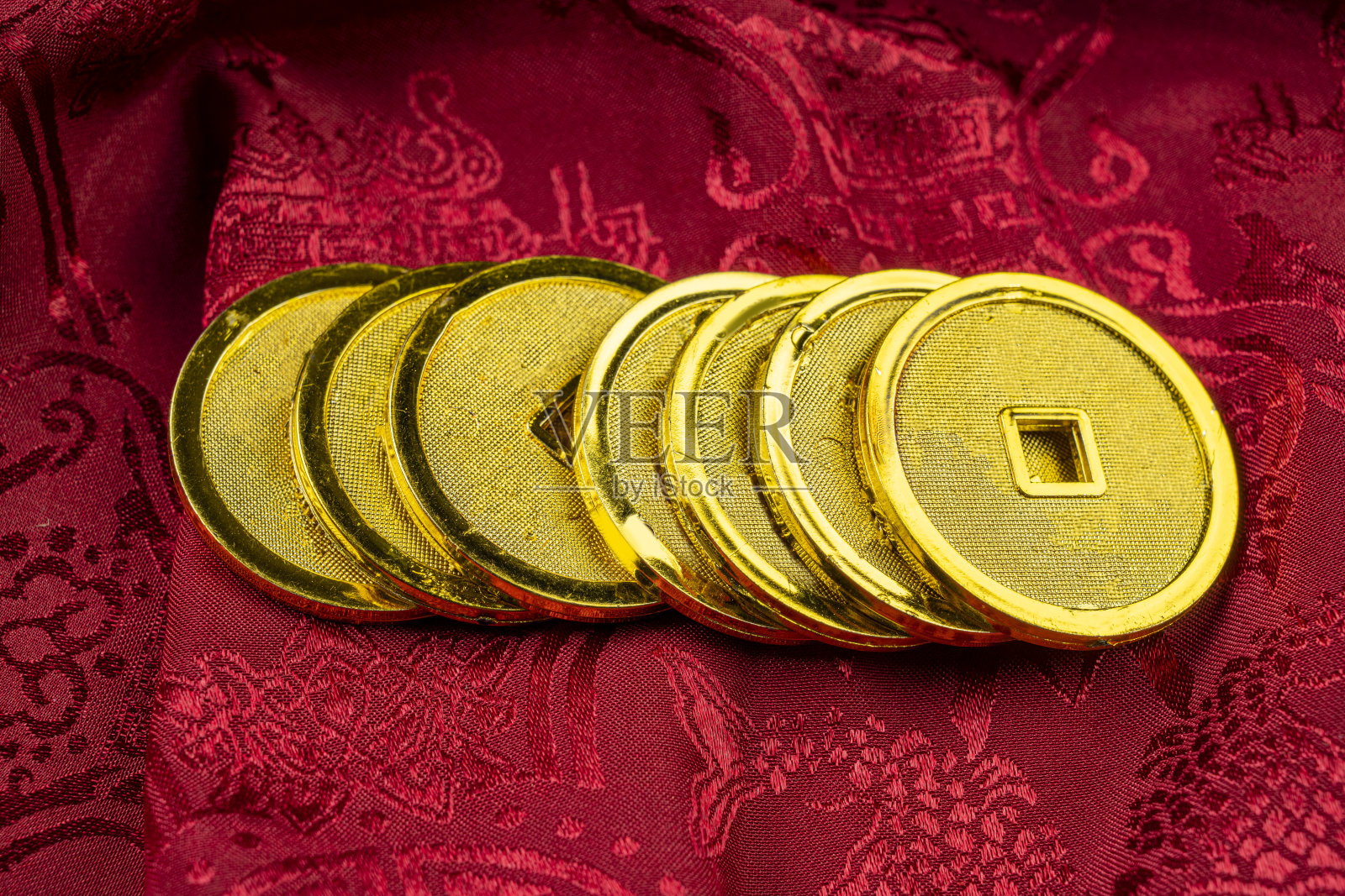 红色布背景上的传统中国金币照片摄影图片