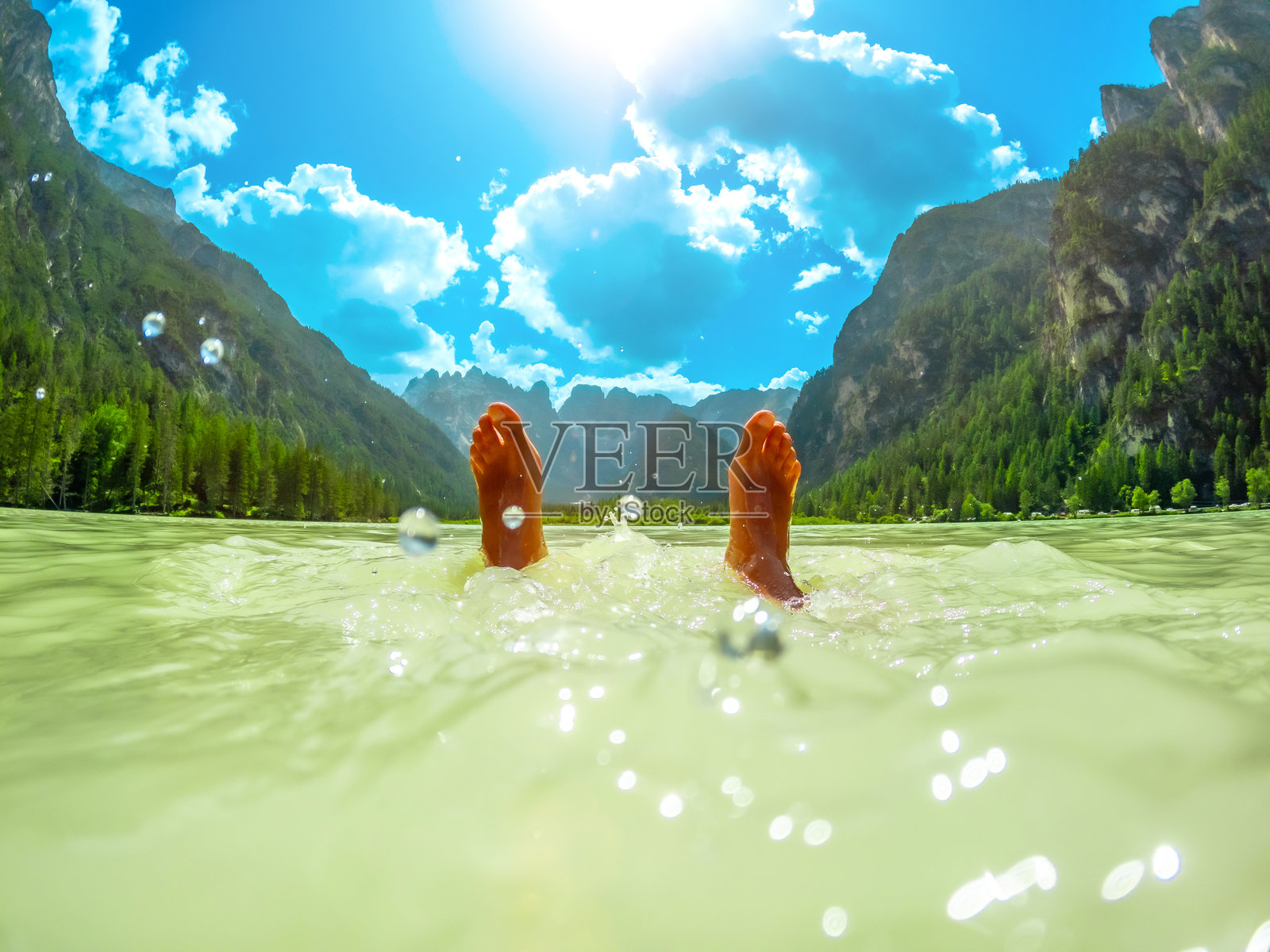 游客在多洛米蒂山脉放松，夏天在兰德罗湖享受清爽的游泳时光照片摄影图片