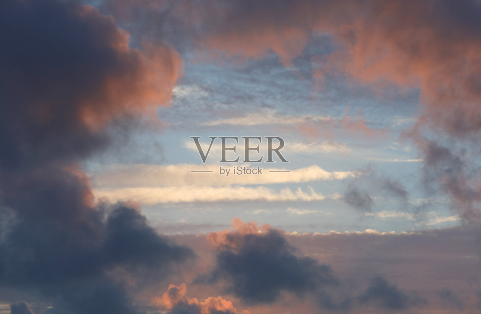 浪漫的天空景观，粉色和橙色的云彩，中央留有空间，适合添加个性化文字，理想的浪漫背景照片摄影图片