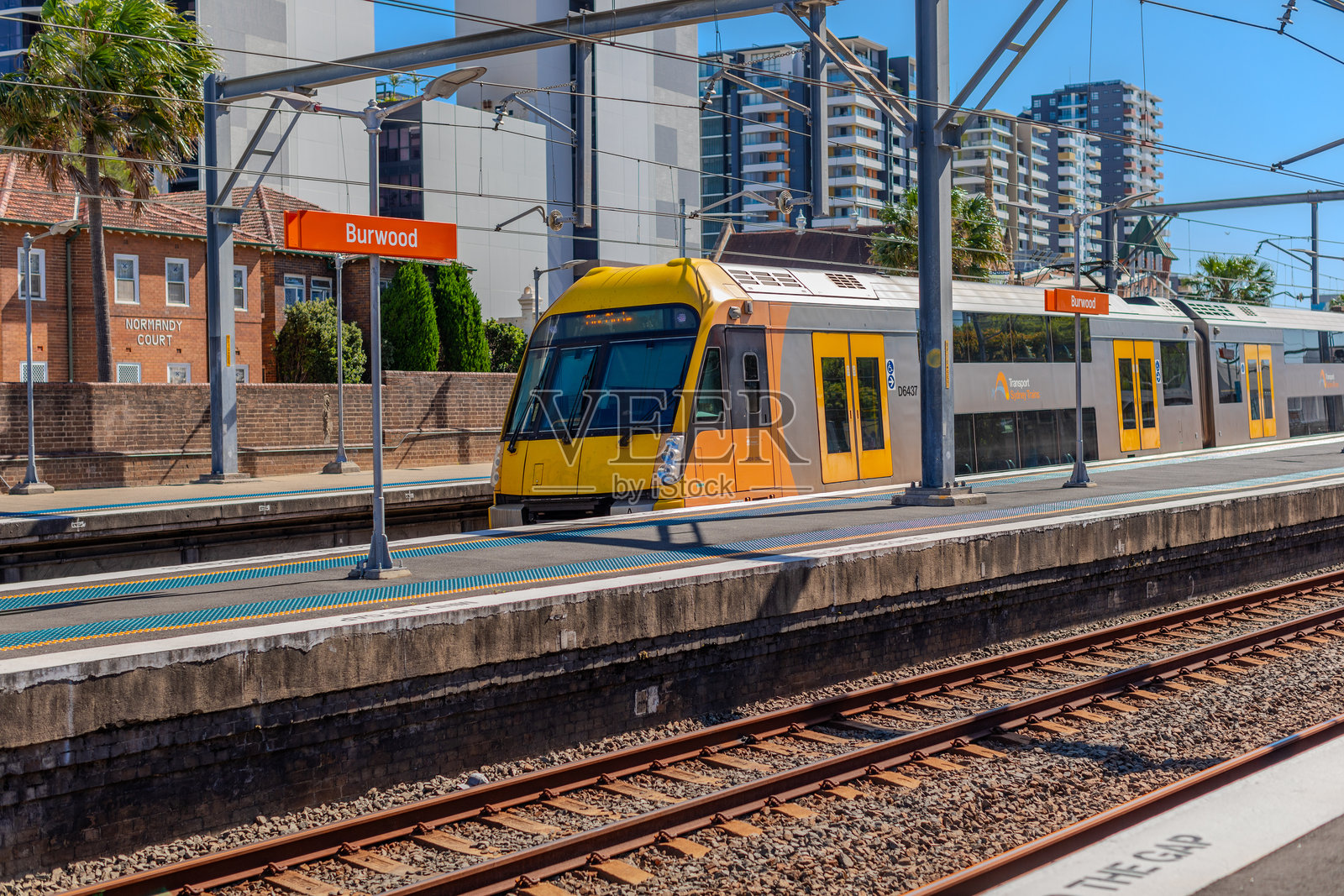 快速行驶的通勤客运列车穿过澳大利亚新南威尔士州悉尼的布尔伍德火车站照片摄影图片