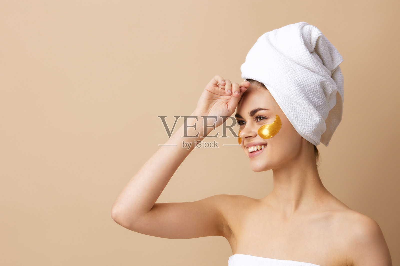 面部有金色斑点的女性肖像，头上裹着毛巾的特写生活方式照片摄影图片