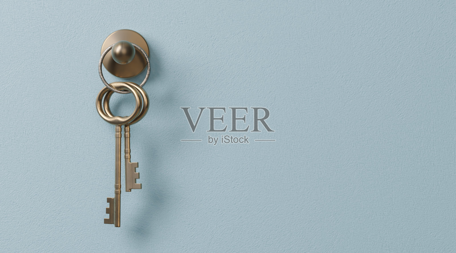 悬挂在灰色背景上的钥匙照片摄影图片