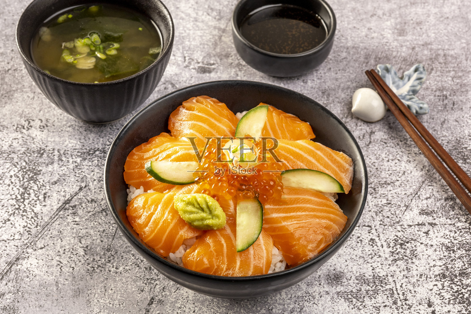 美味的丼饭，顶部是生鱼片三文鱼和鱼子酱。照片摄影图片