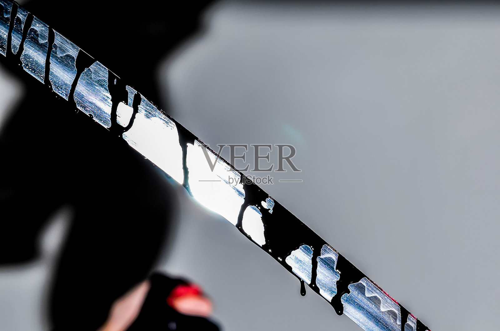 一个人手持一把黑白条纹的刀。照片摄影图片