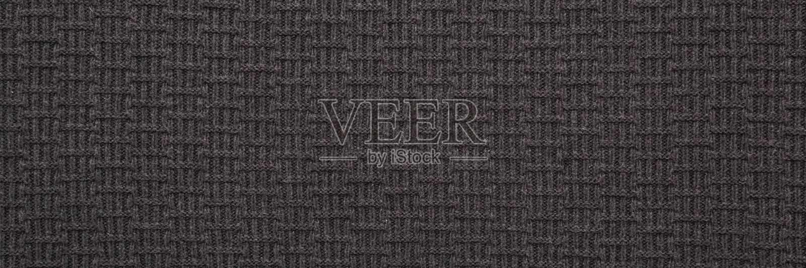 深黑色柔软针织面料背景。文本的空白位置。特写。宽幅横幅。俯视图。照片摄影图片