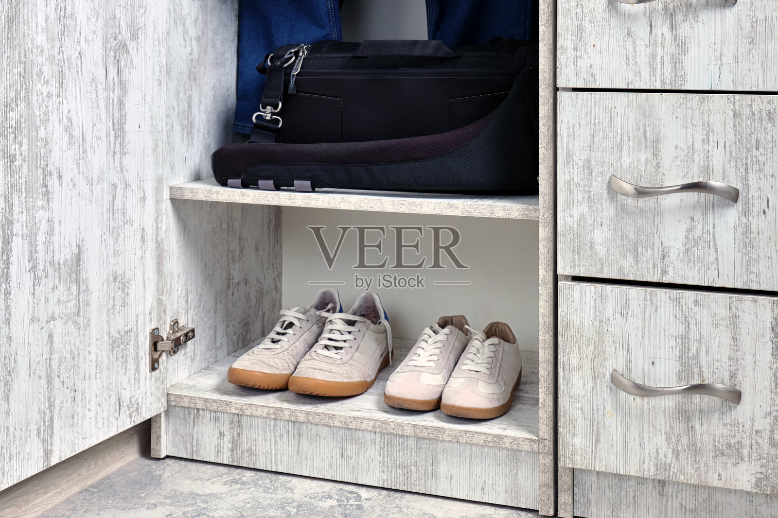 小公寓里衣物和鞋子摆放整齐的开放式衣橱特写。照片摄影图片