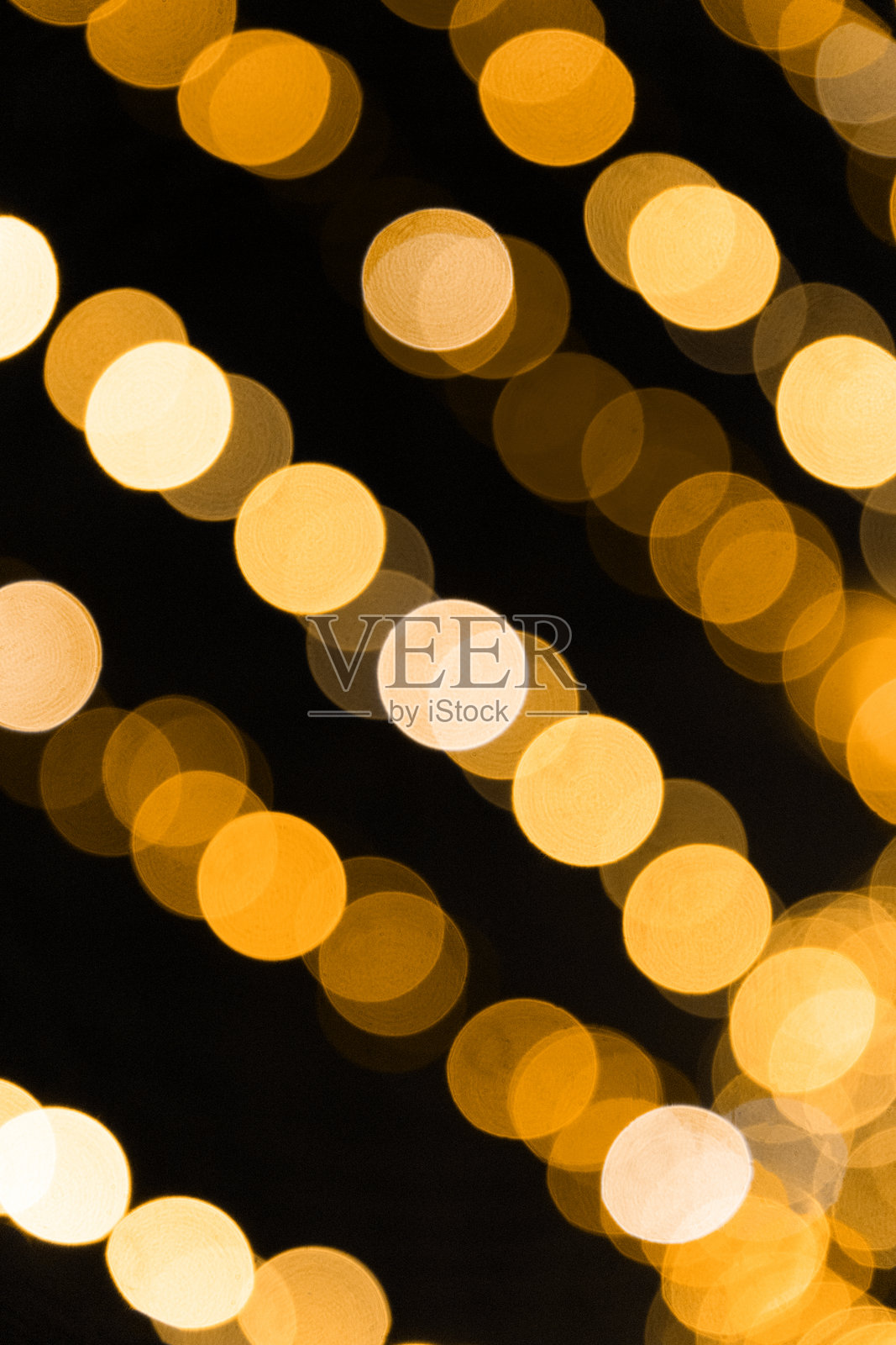 黑色背景上的金色散景光斑纹照片摄影图片