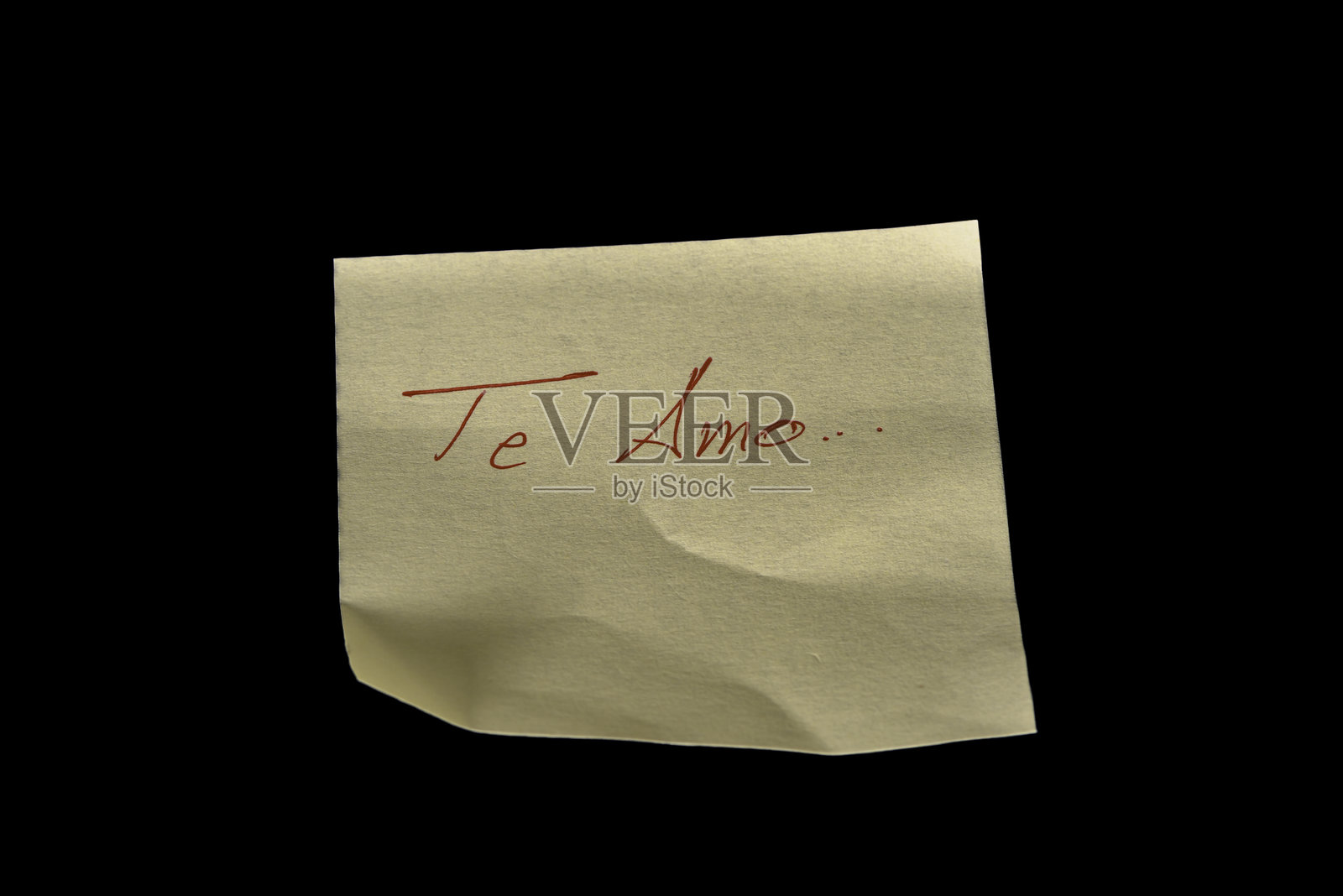 黑色背景上的黄色粘性纸，类似于便签，上面用红色墨水手写着“Te Amo”。照片摄影图片