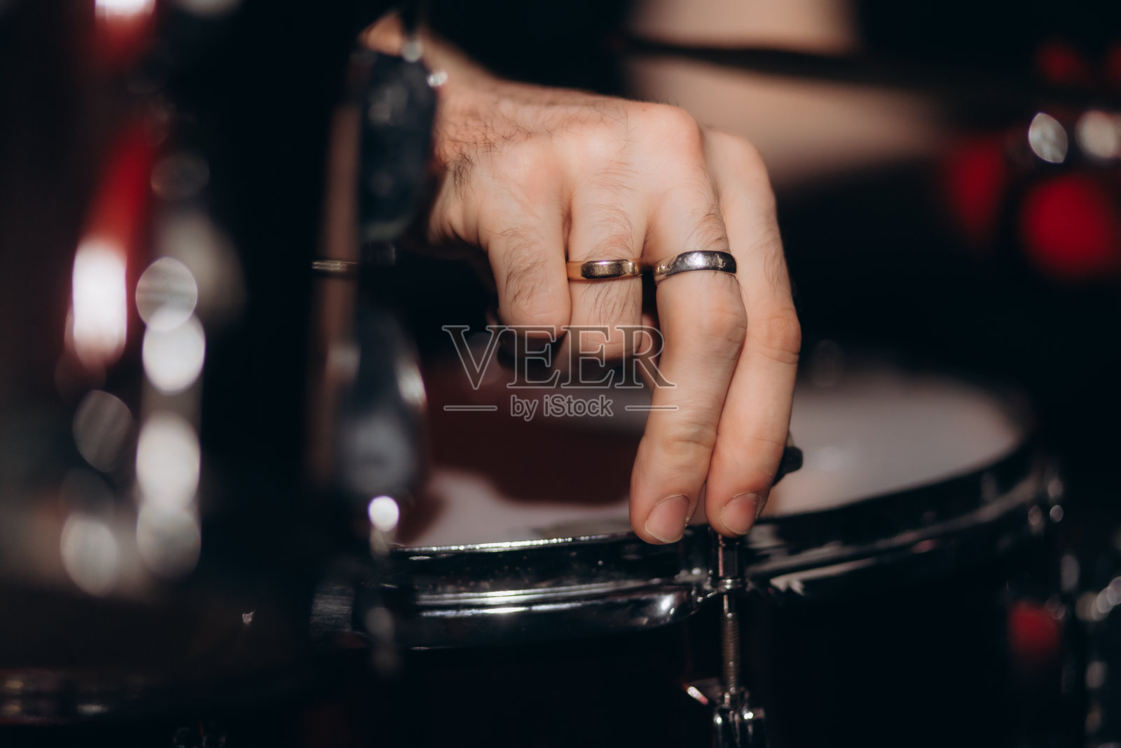 鼓手正在调整鼓组。场景。舞台灯光。照片摄影图片