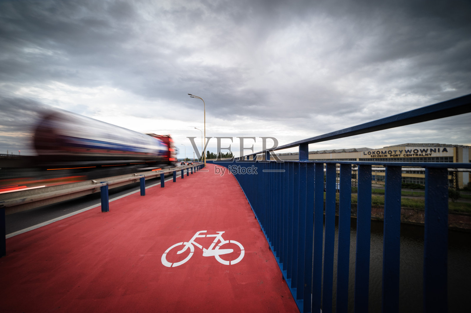 斯泽琴的桥上有自行车道和快速行驶的卡车。照片摄影图片