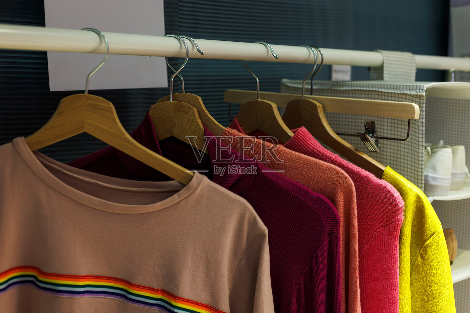 五颜六色的T恤挂在架子上照片摄影图片