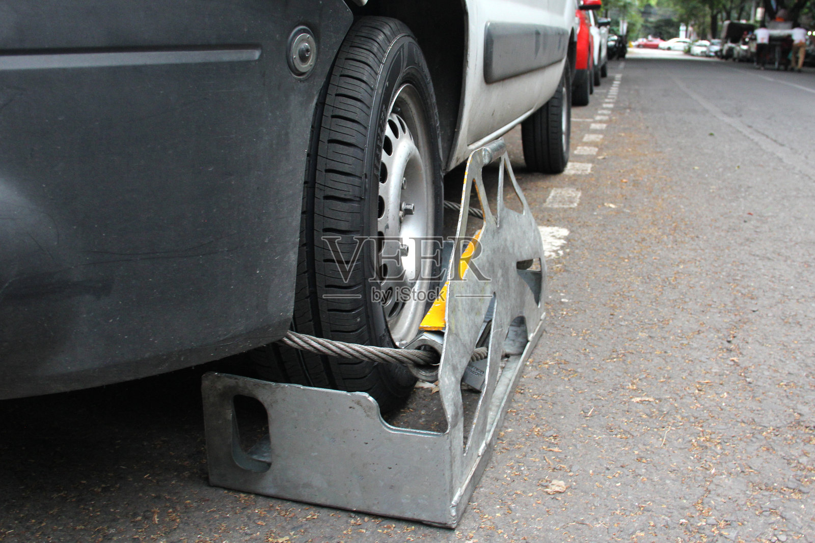 警察和交通执法人员使用的轮胎锁定装置，用于锁定违反法律的机动车辆。照片摄影图片