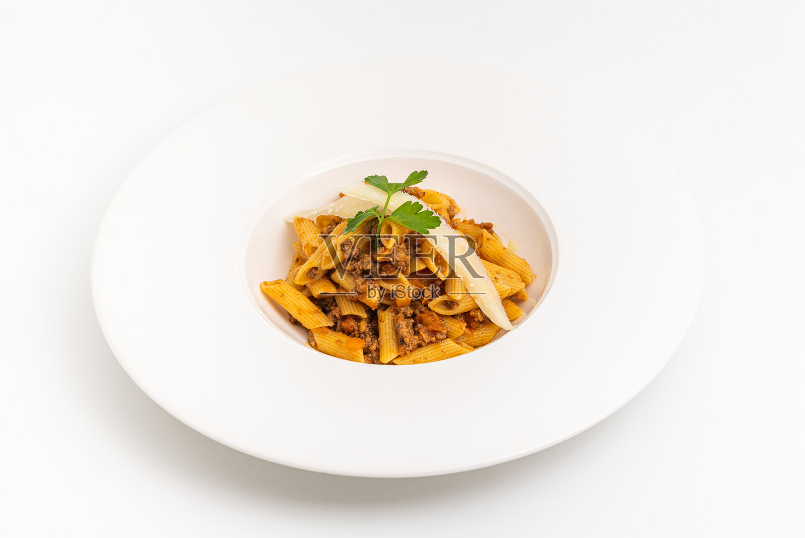 木桌上白色盘子里的意大利笔管面配博洛尼亚酱的俯视图照片摄影图片