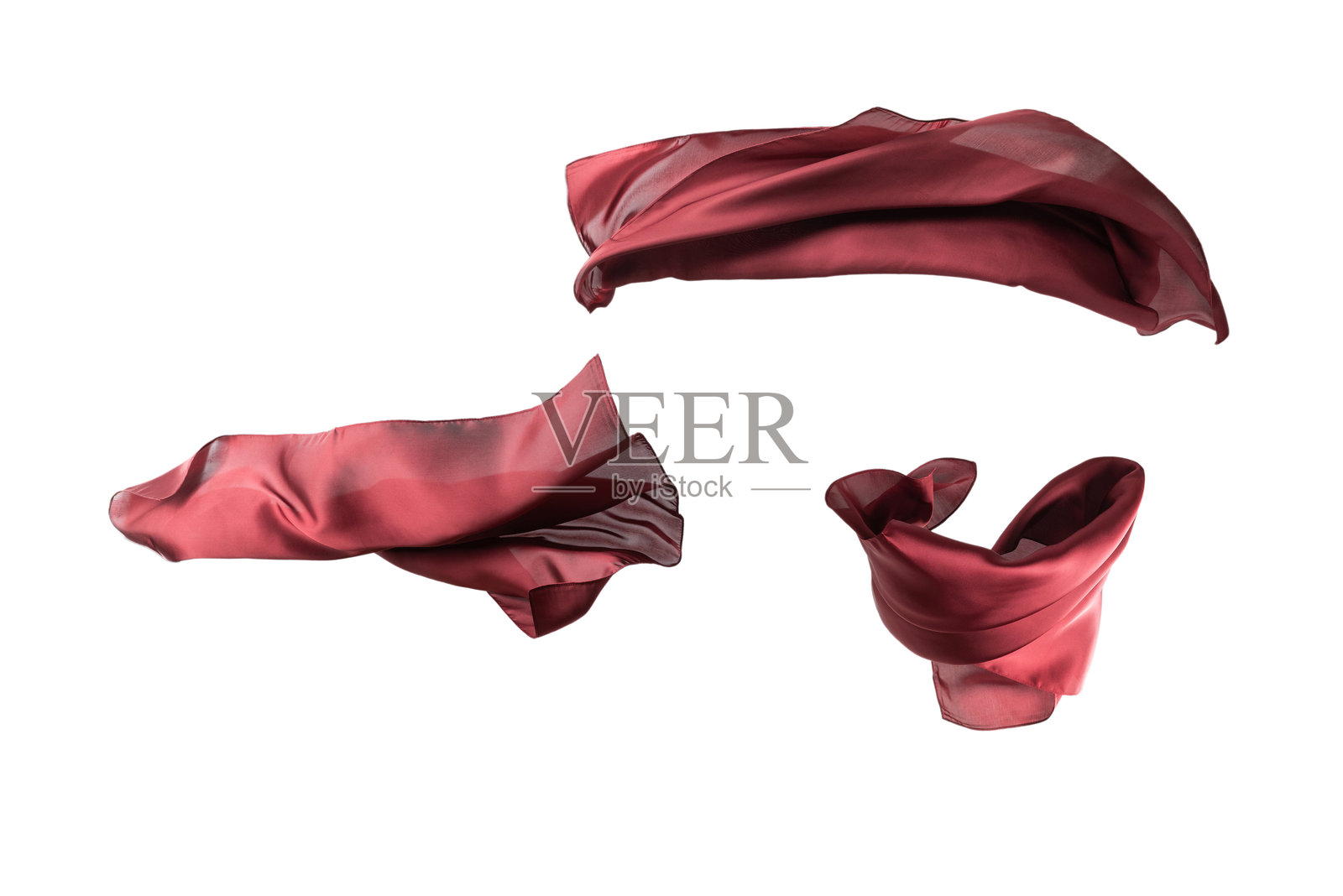 在白色背景上飘动的红色丝绸围巾。照片摄影图片