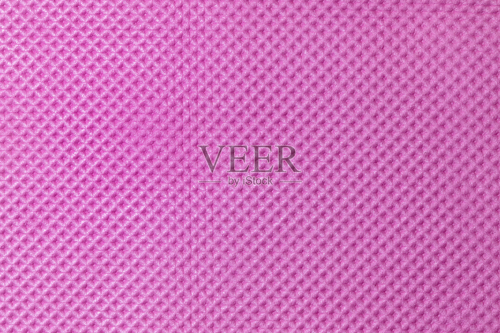 粉色纹理表面的特写，展示了复杂的细节和鲜艳的色彩。照片摄影图片