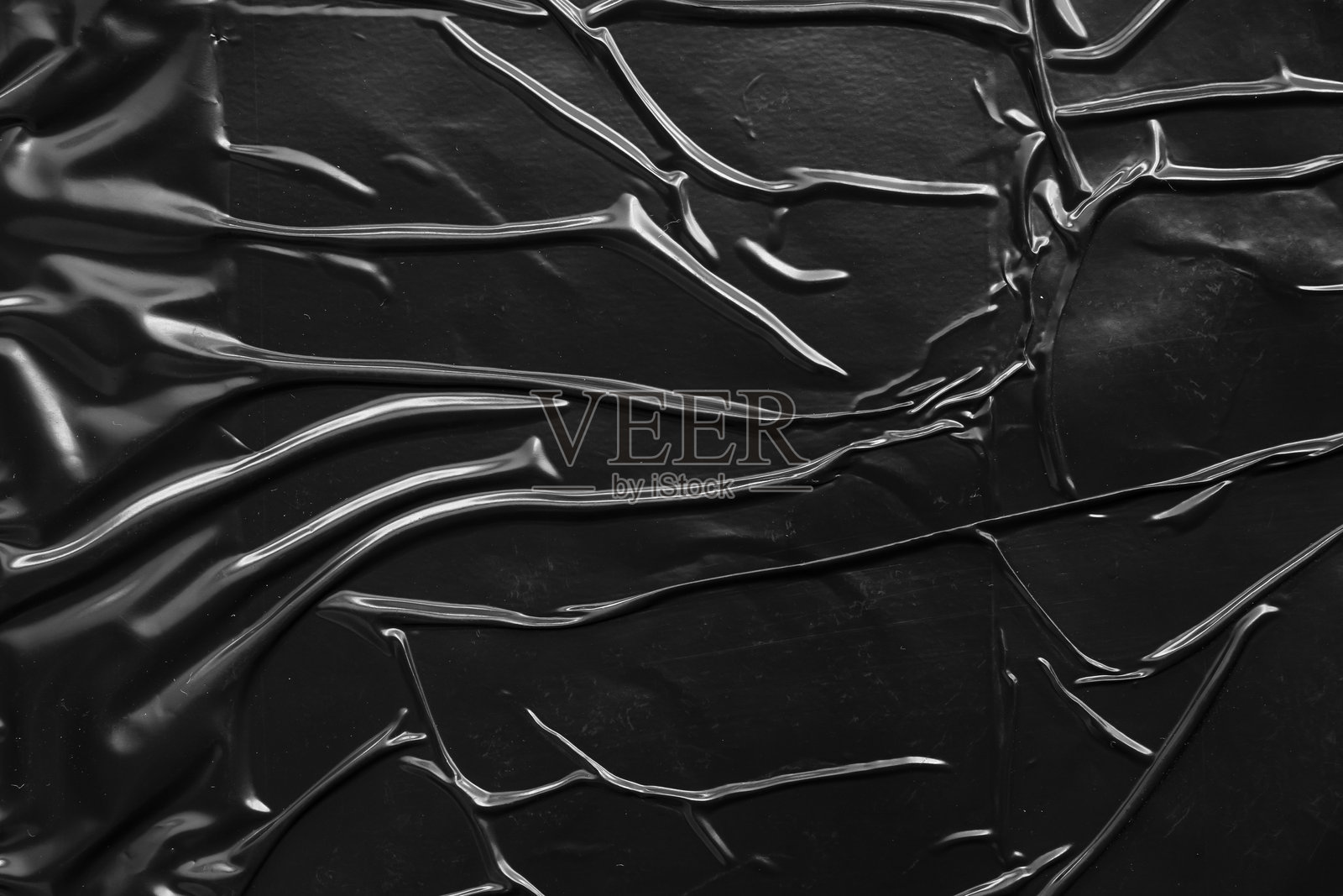 黑色皱褶和折痕的塑料海报纹理背景照片摄影图片