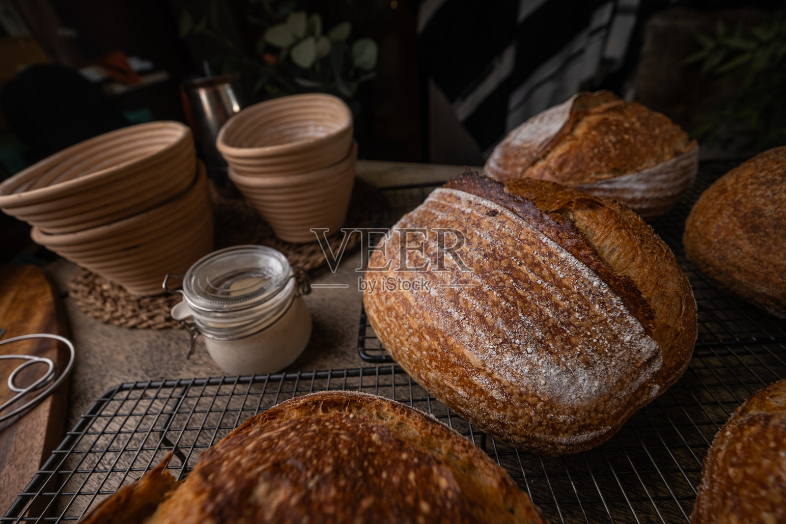 新鲜出炉的乡村手工酸面包放在木桌上。照片摄影图片
