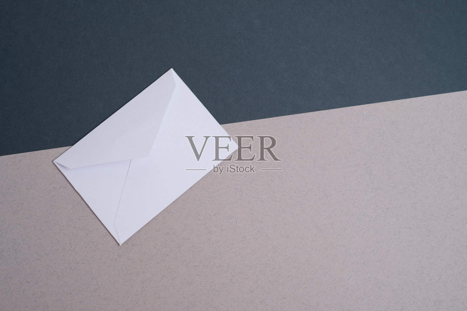 浅色背景上的纸质信封。新邮件，写信息。发送和接收邮件。邮政快递服务。空信封，空白空间。与人沟通，文书工作。信封特写。照片摄影图片