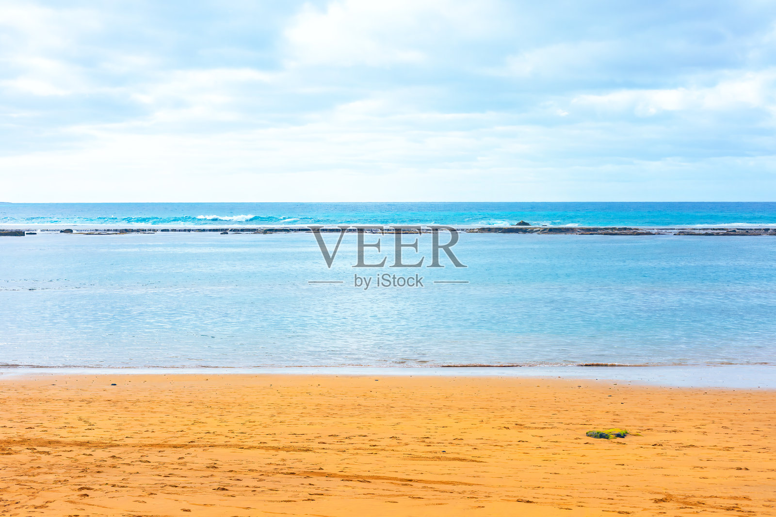 宁静的海滩场景，金色沙滩与平静的海洋照片摄影图片