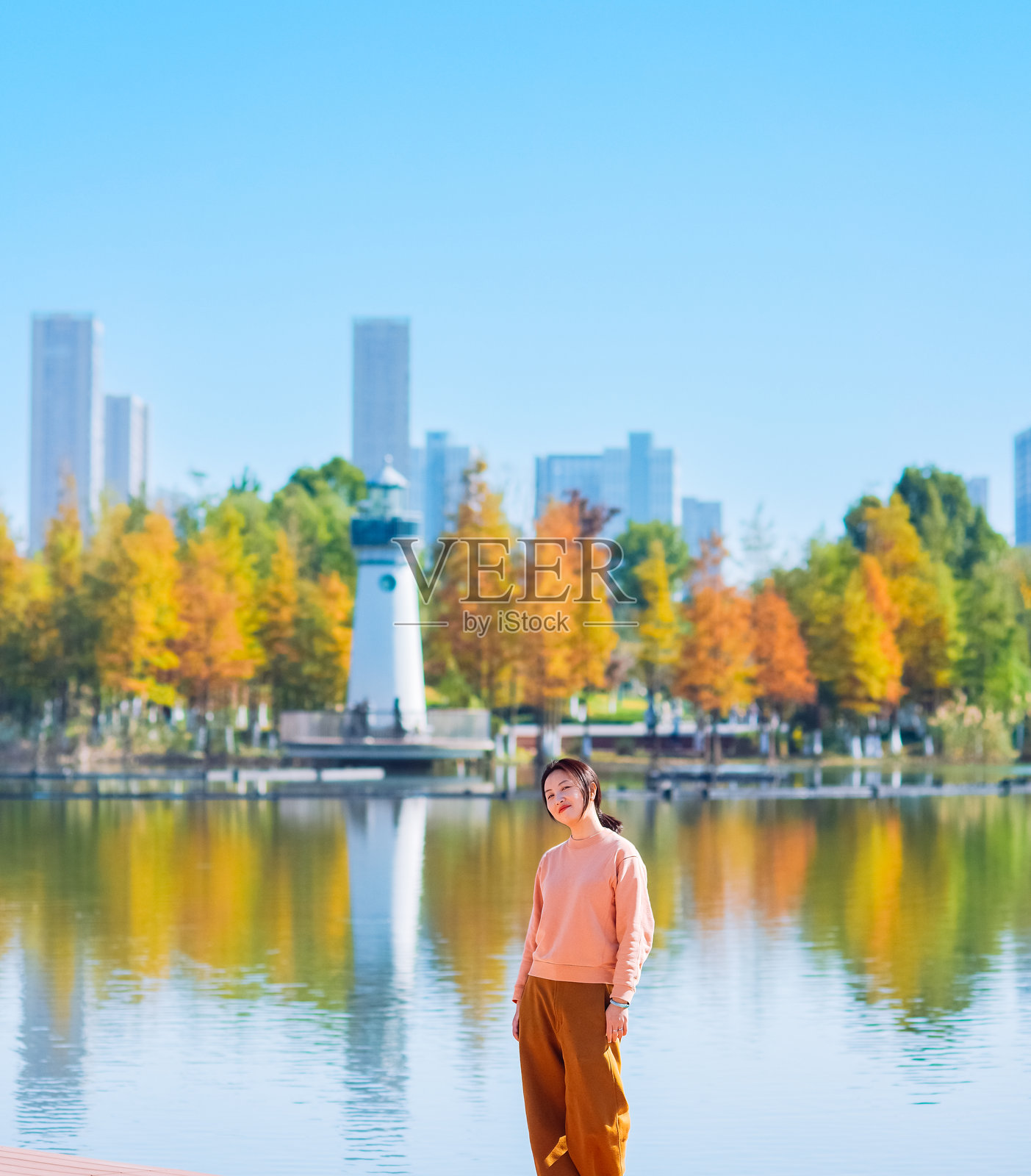 一位亚洲女性在中国宁波的鄞州公园享受秋季风景照片摄影图片