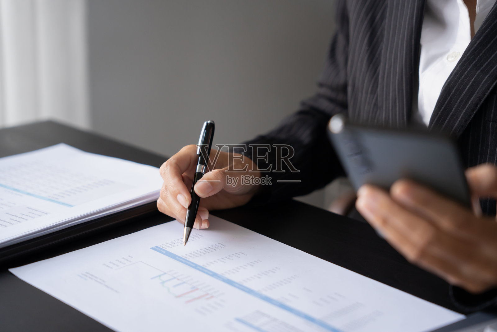 亚洲女商人使用智能手机查看新闻和社交媒体。照片摄影图片