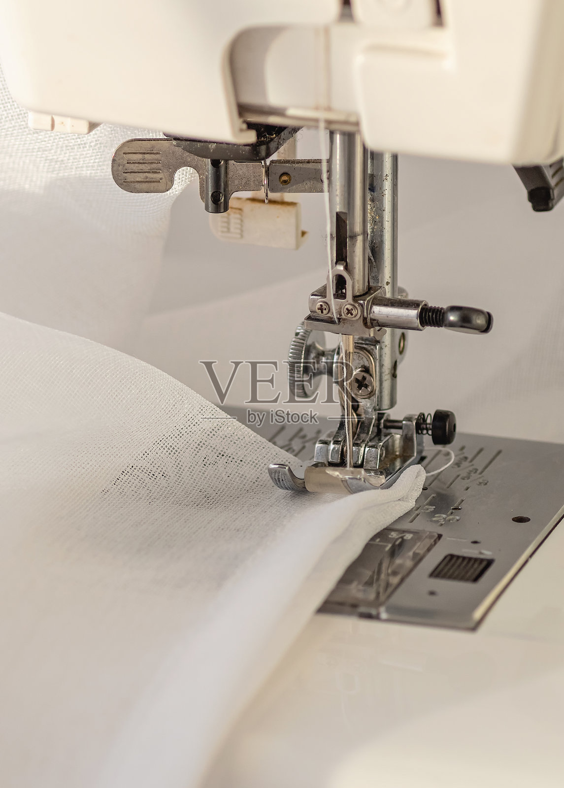 缝纫机特写缝制白色薄纱照片摄影图片
