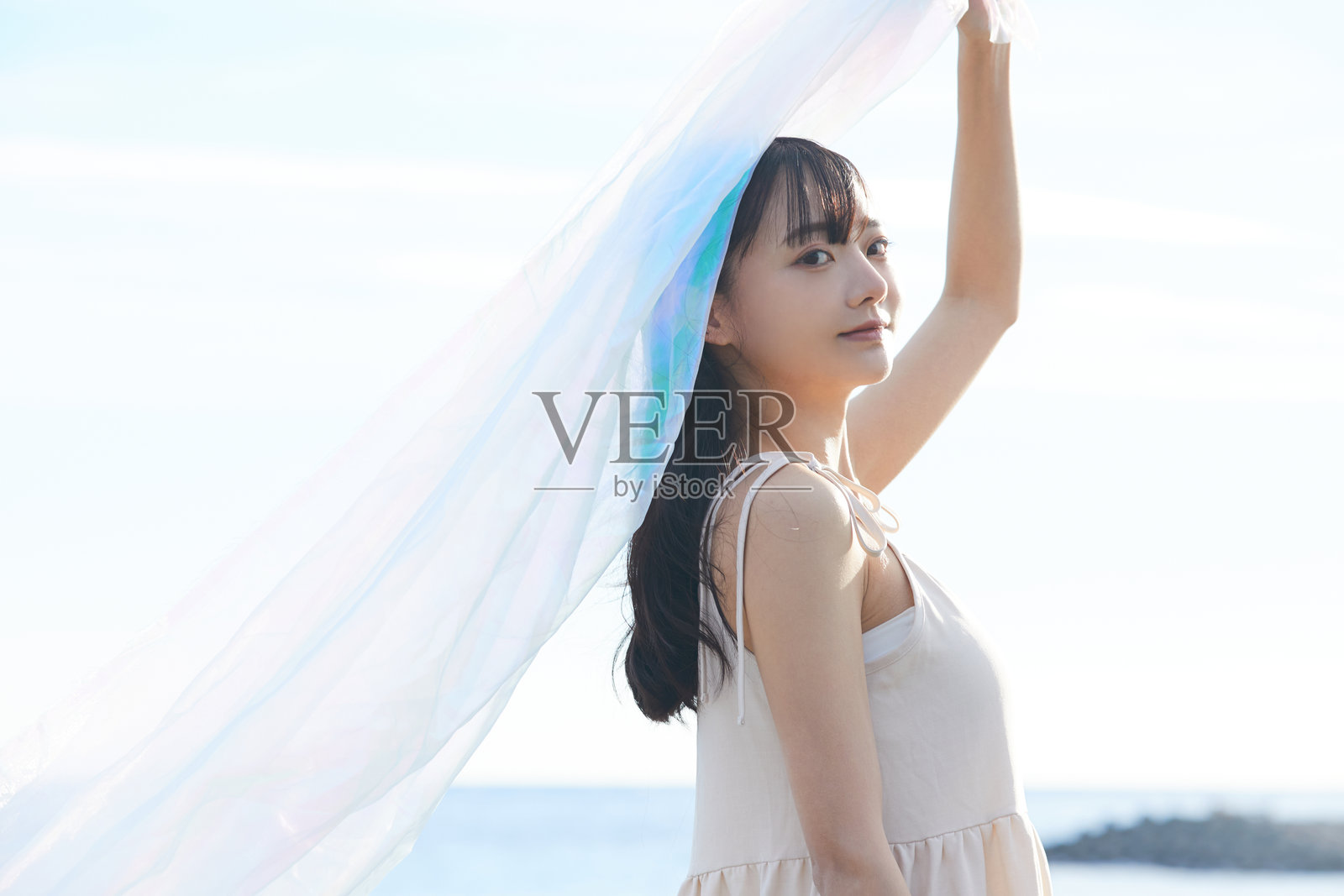 年轻的亚洲女性在海滩上漫步照片摄影图片