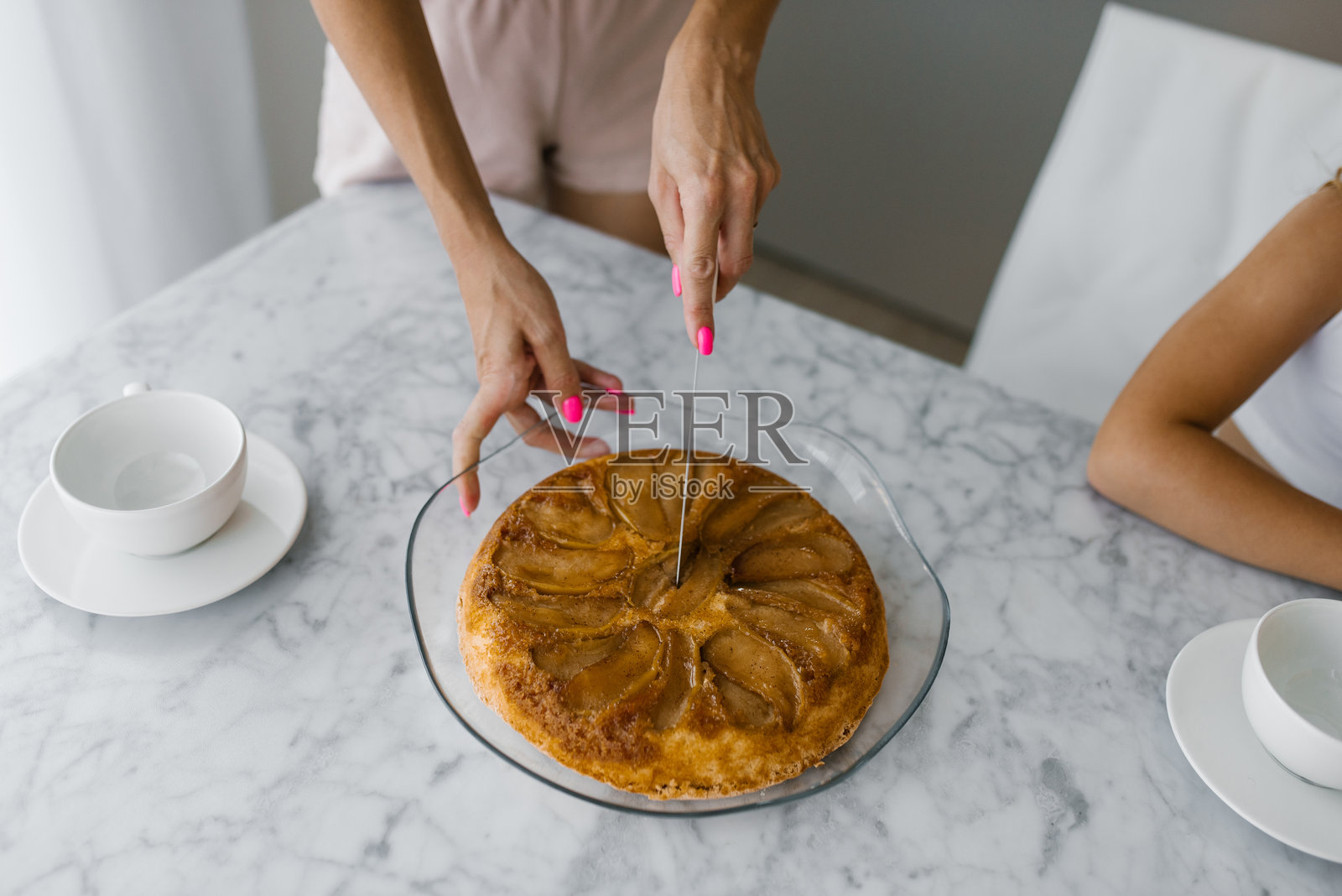母亲的手在桌子上为孩子切一块黑莓派的特写镜头照片摄影图片