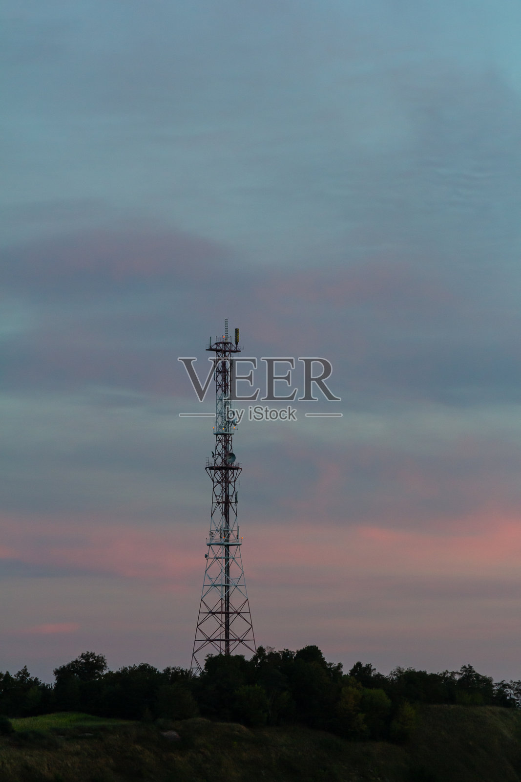 通信塔矗立在乡村地区黄昏时分多彩的天空下照片摄影图片