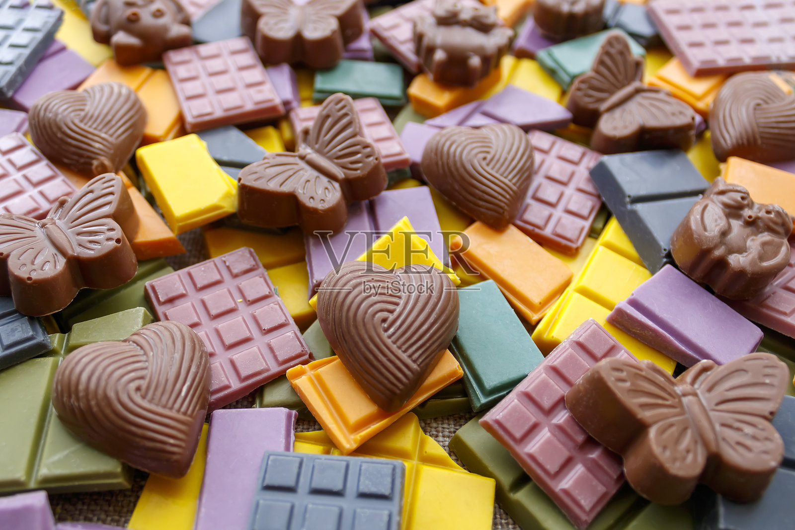 多彩背景上的巧克力糖果照片摄影图片