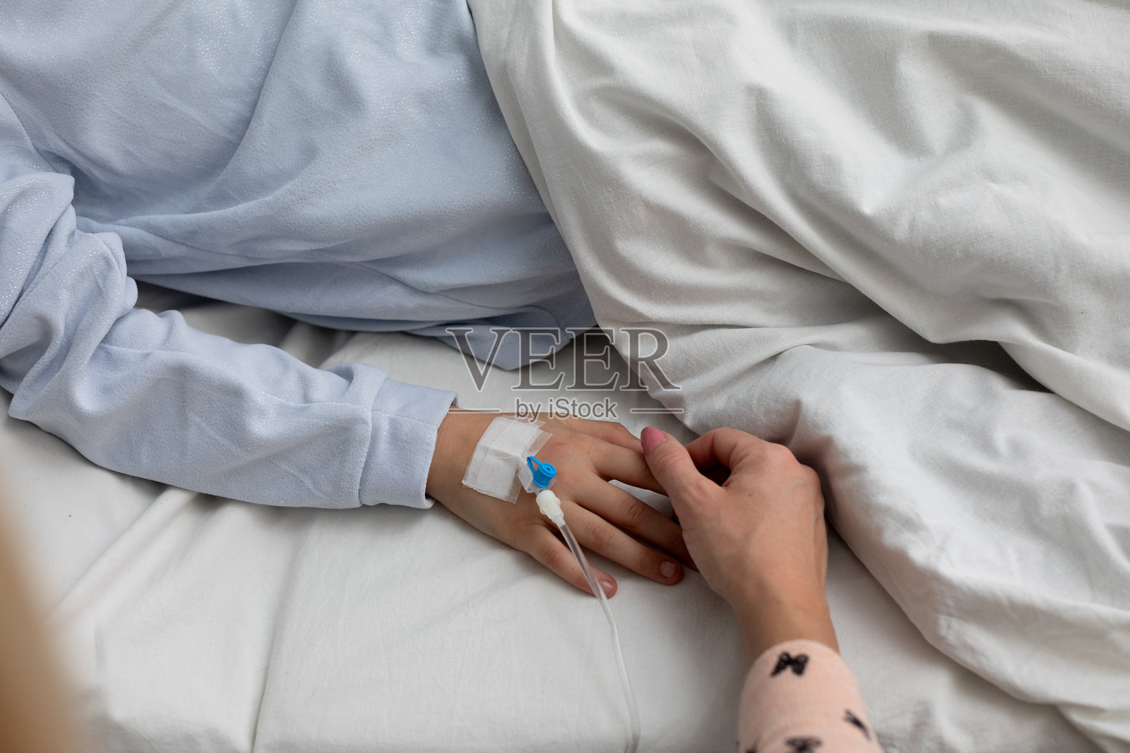 在医院环境中握手的温馨时刻，提供安慰和情感支持照片摄影图片