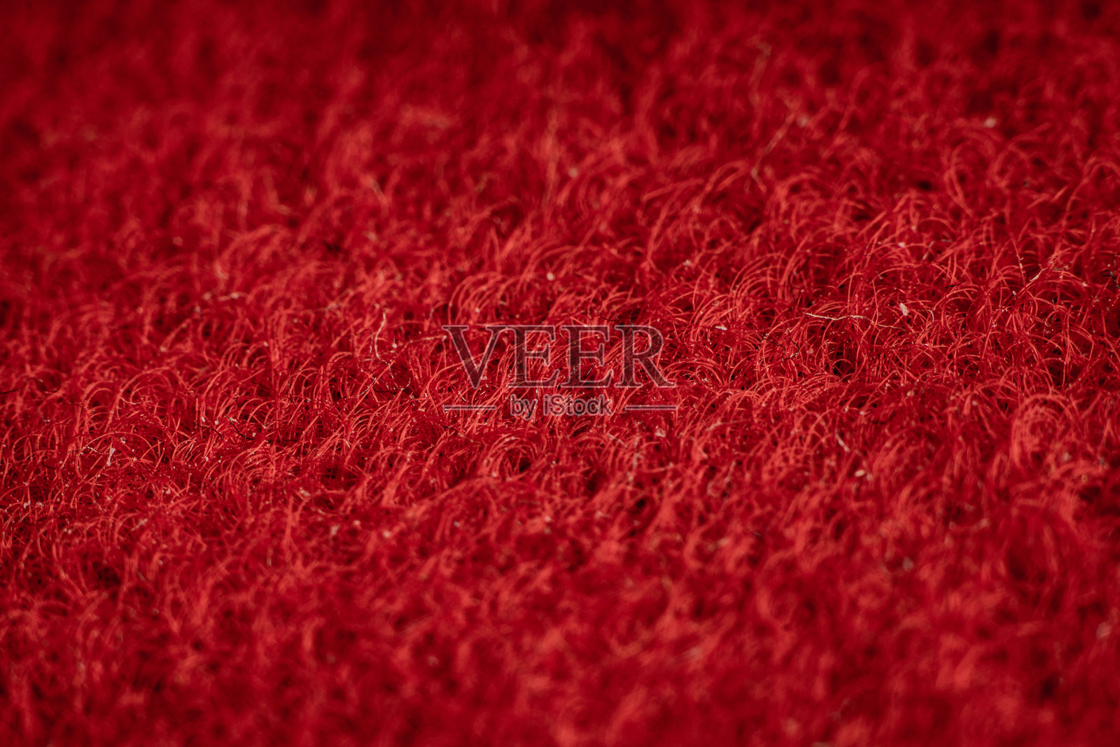 深红色的丰富纹理面料，展示独特的编织图案，适合复古装饰和时尚。照片摄影图片