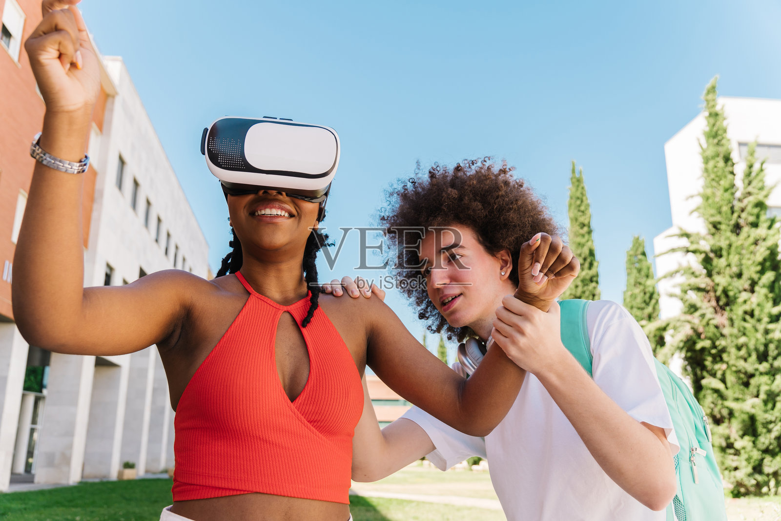 现代科技与教育。两名学生在尝试虚拟现实眼镜时欢笑。照片摄影图片