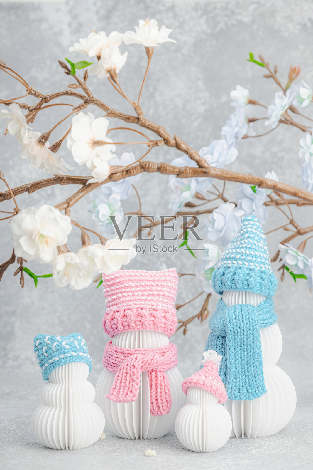 快乐的雪人家庭在樱花树下。可爱的贺卡，周年庆祝概念，生日。照片摄影图片