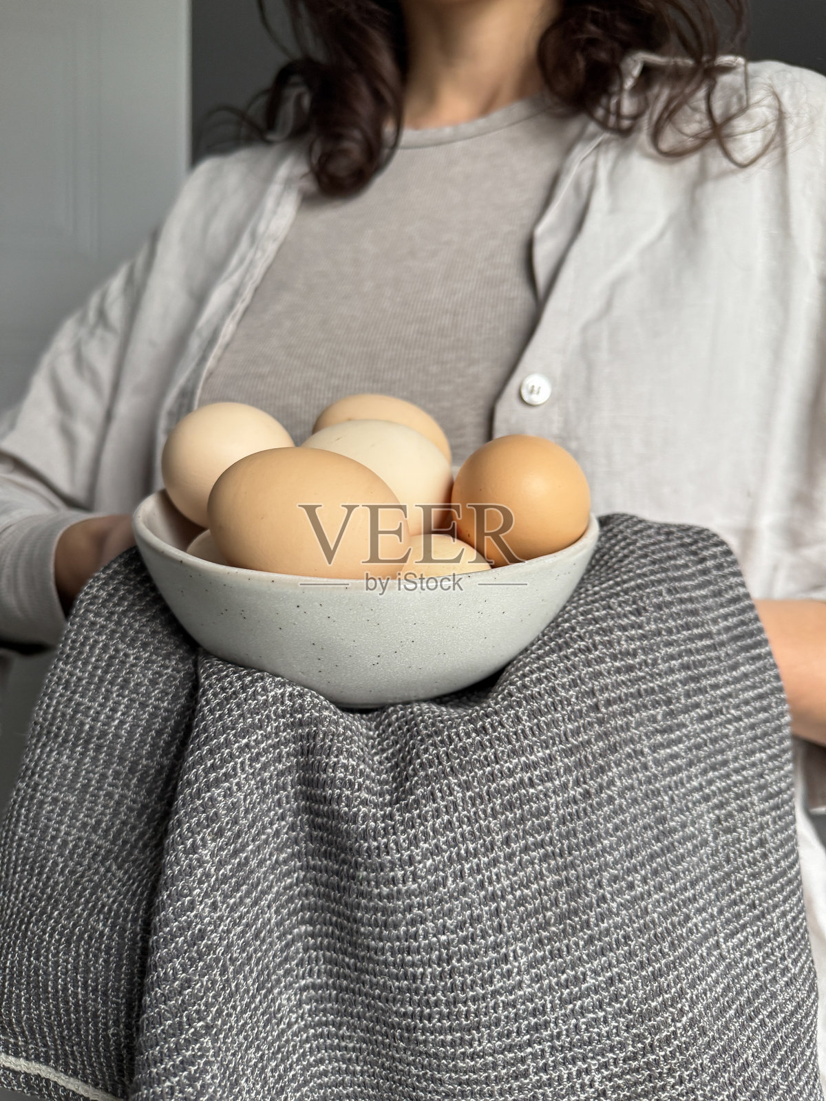 女人将新鲜的农场鸡蛋放在碗里照片摄影图片