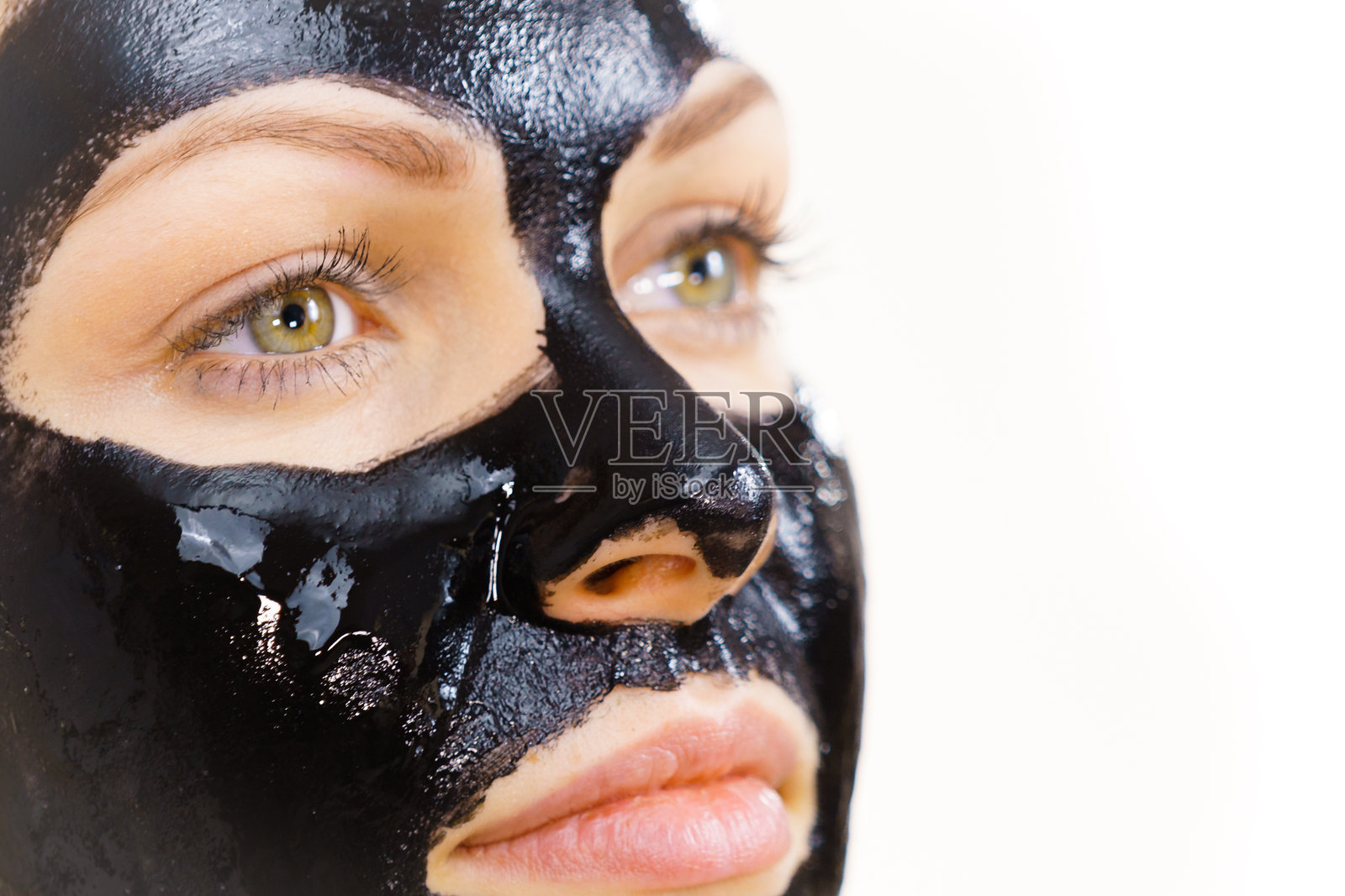 脸上涂有黑色撕拉面膜的女性照片摄影图片