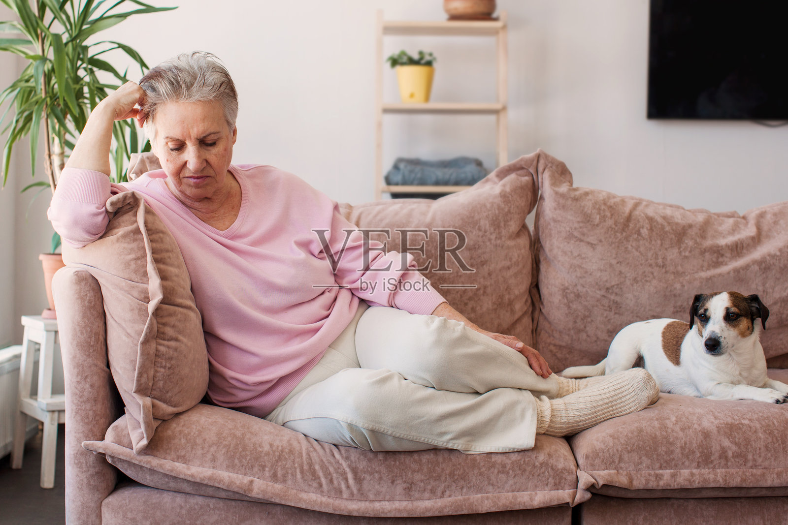 中年女士独自坐在家中，感到焦虑、孤独和悲伤。照片摄影图片
