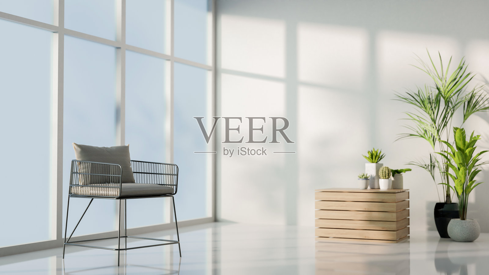 一个极简风格的简单房间，窗边有一把扶手椅和一些装饰性的室内植物。照片摄影图片