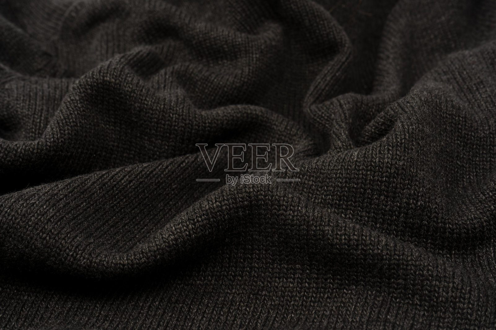 深灰色毛衣纹理作为背景。编织图案。照片摄影图片