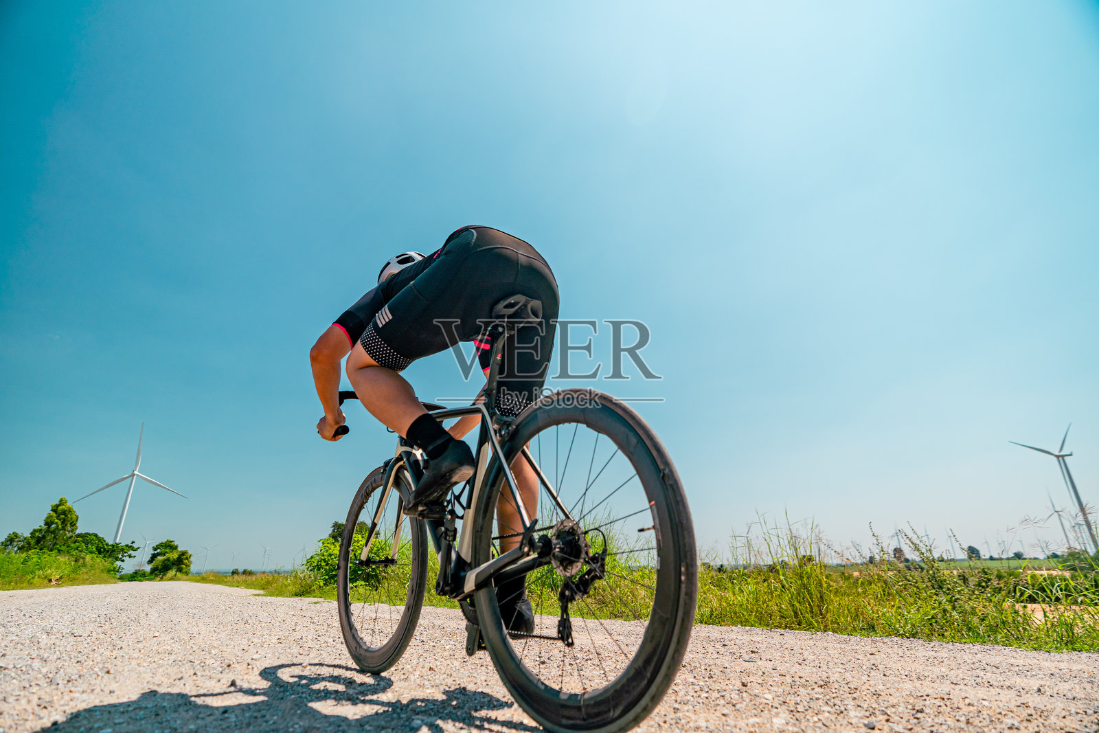 骑自行车的人在碎石路上骑行。照片摄影图片