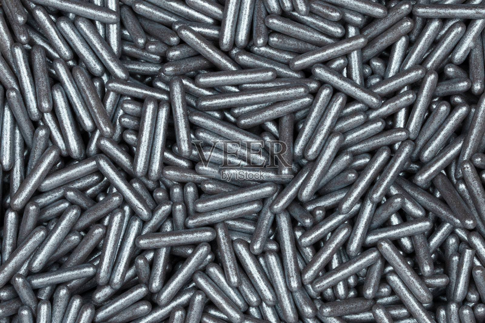 闪亮的银色糖果撒粉特写 - 金属可食用糖果装饰，用于烘焙、蛋糕装饰、甜点和节日糕点照片摄影图片