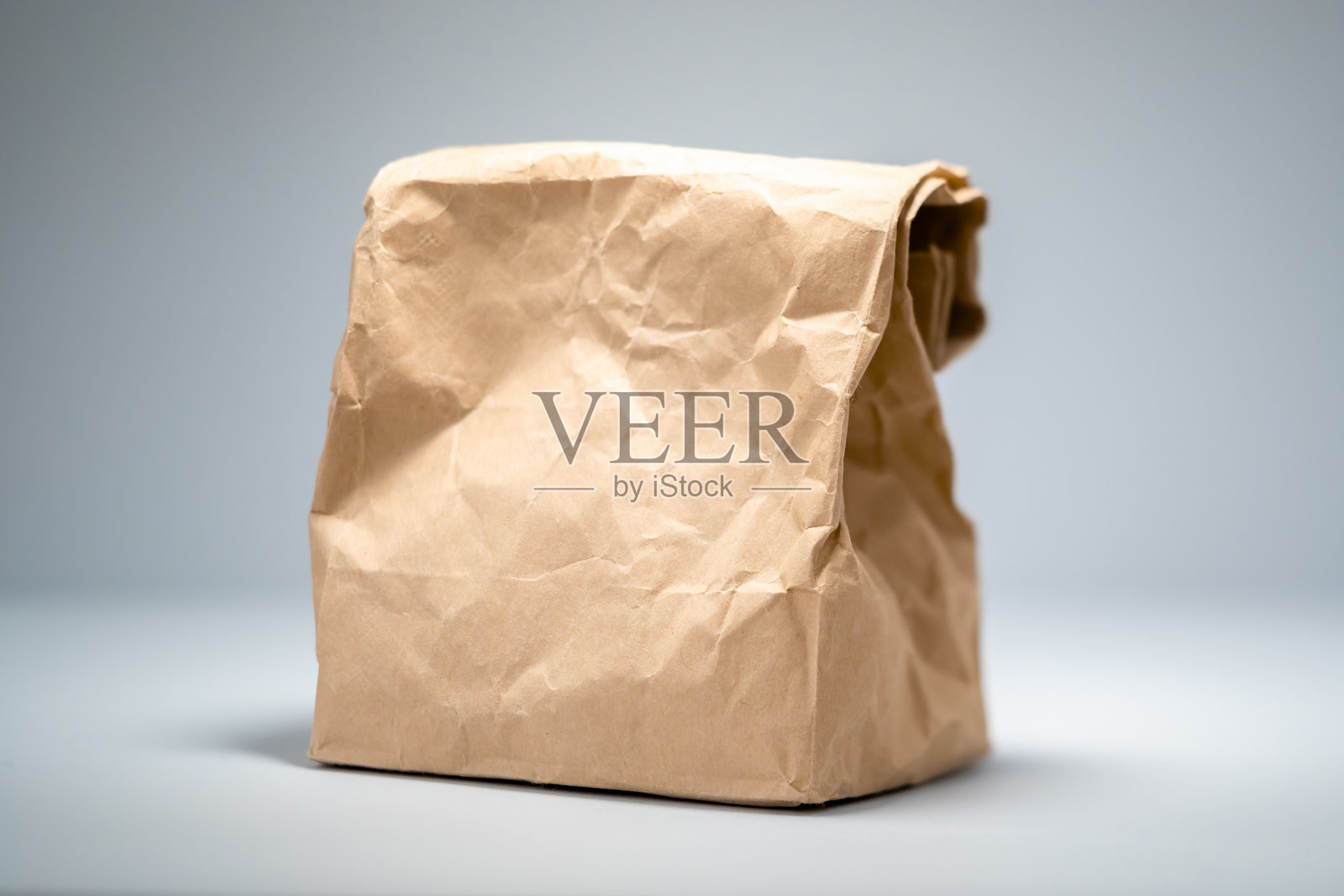 棕色纸袋，内含未知物品，背景中性照片摄影图片