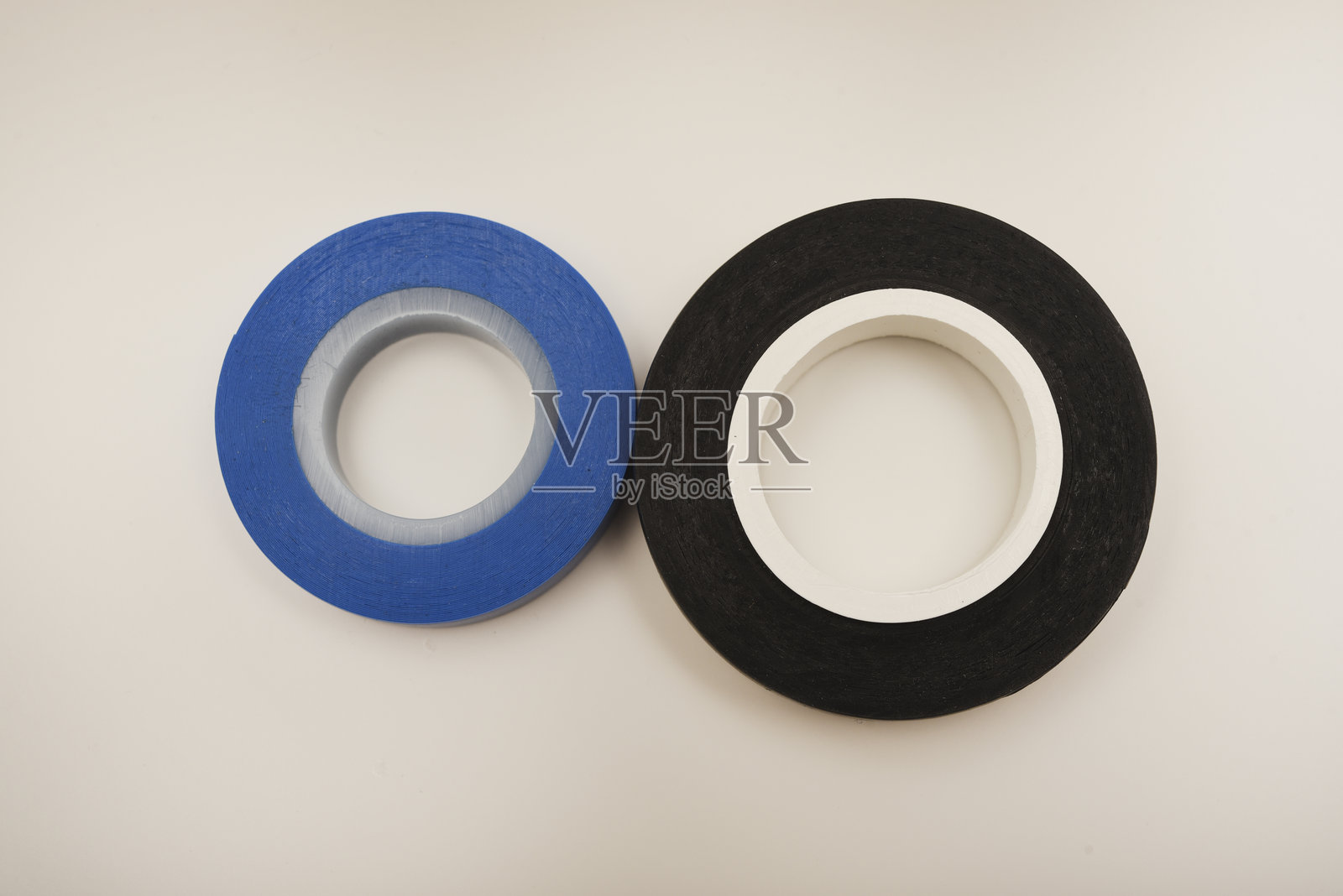 黑色和蓝色的电工胶带在白色背景上。电子设备用绝缘胶带。照片摄影图片