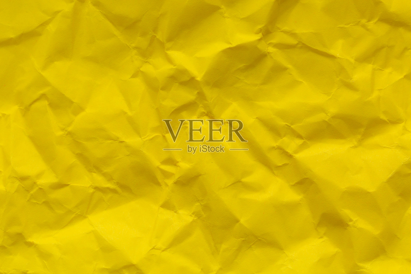 黄色皱纹纸背景，皱纹纸质感。抽象黄色背景照片摄影图片
