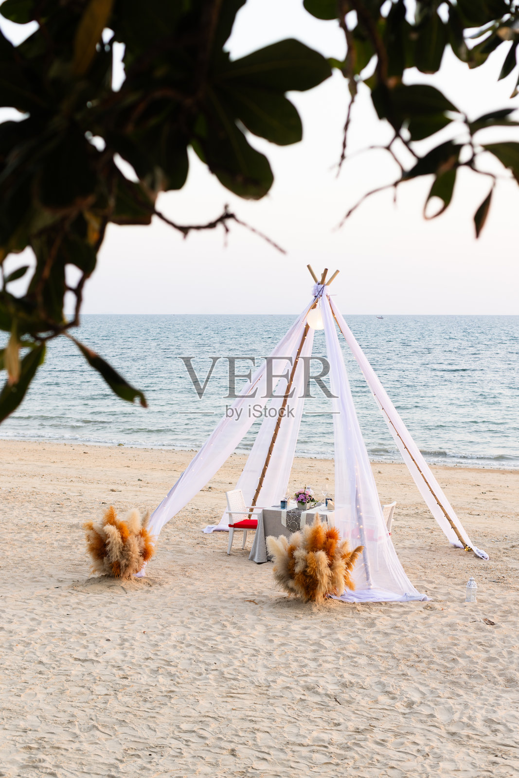 热带海滩上的浪漫双人餐桌照片摄影图片